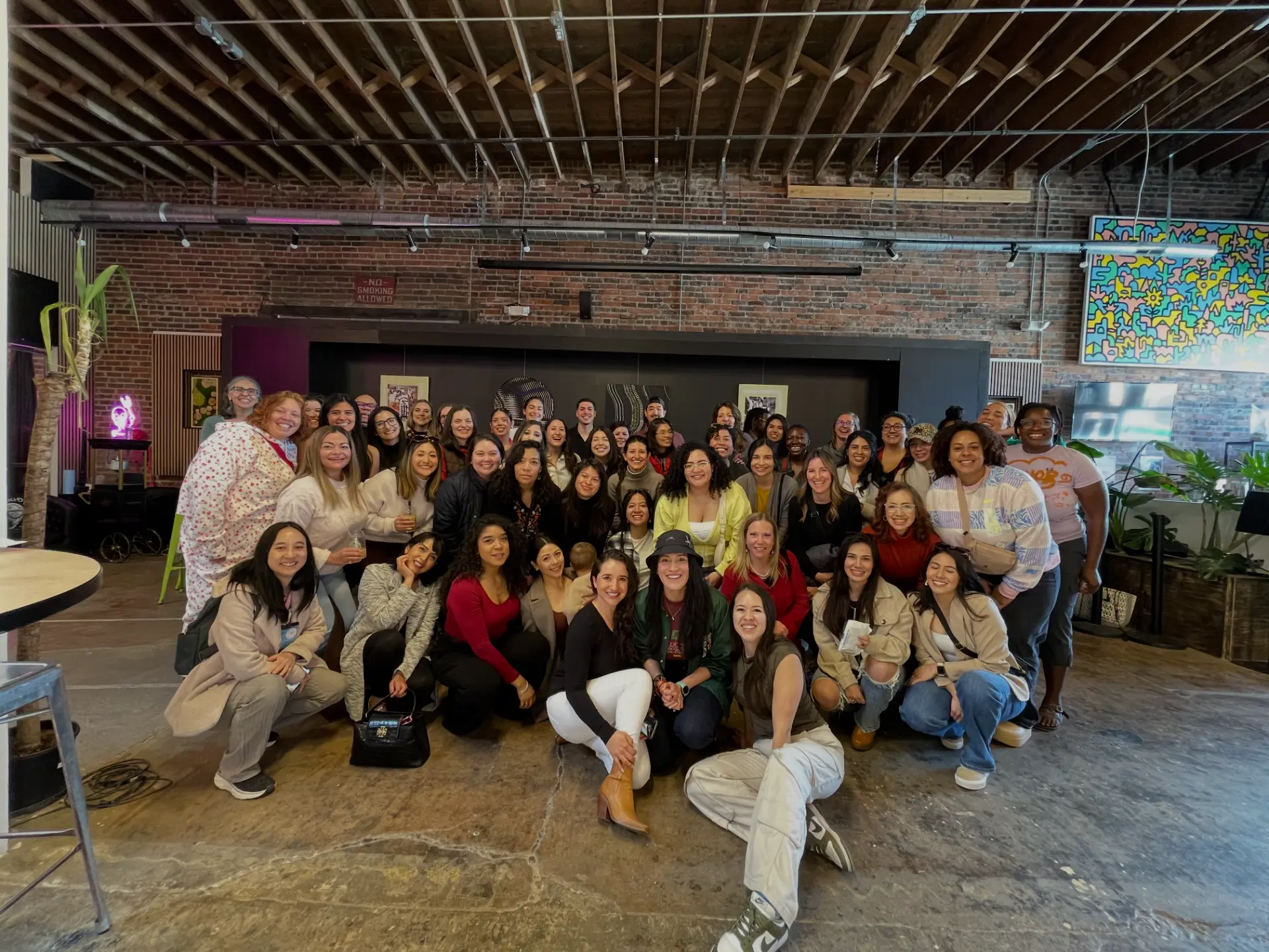 Amigas in Tech members gathered at a community meetup